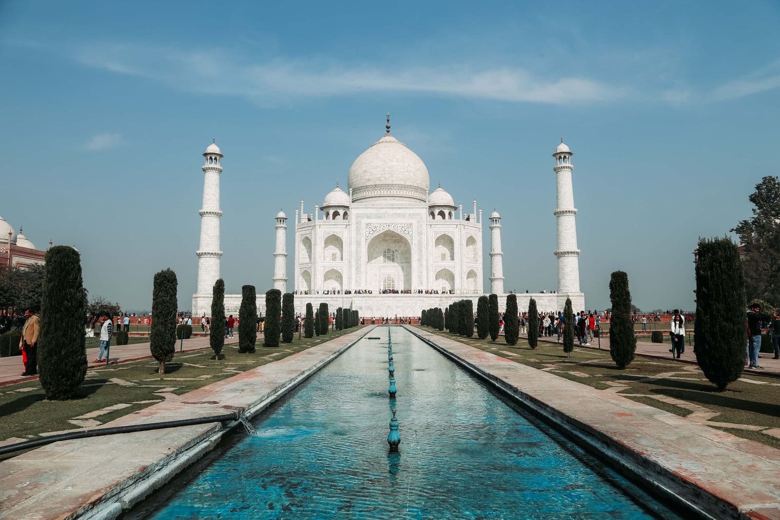 The Taj Mahal and its long reflecting pool under a blue sky