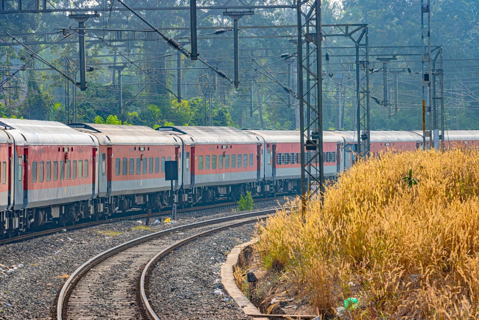 An Indian Railways train curving along the tracks